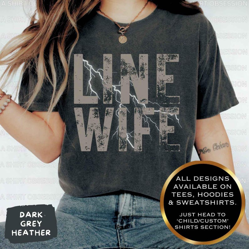 May include: A dark heather grey t-shirt with the text "LINE WIFE" in white with a lightning bolt graphic. The text is distressed and has a vintage look. All designs are available on tees, hoodies, and sweatshirts. Just head to the 'Child/Custom' shirts section.