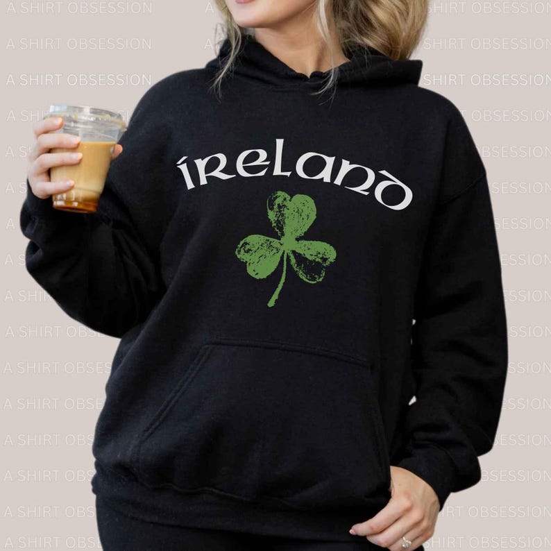 May include: Black hoodie with a white graphic of a shamrock and the word "ireland" in white.
