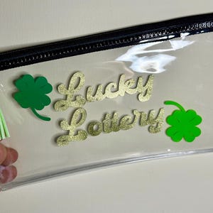 Lucky Lottery - Carteira de plástico transparente com zíper para loteria e amuletos da sorte. Detalhes personalizados em vinil dourado e verde. Porta-bilhete de loteria