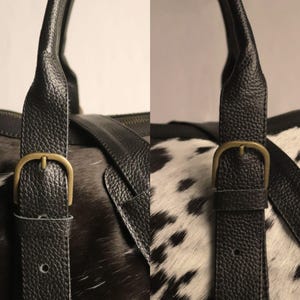 Personalized Large Cowhide Duffel Bag made from genuine hair-on leather. This unisex, handmade travel bag is perfect for weekend getaways or daily use. Spacious and stylish with multiple compartments, it offers both function and flair. The adjustable strap adds comfort, while real cowhide ensures each bag is unique. A thoughtful gift for him or her. Note: Natural cowhide patterns vary, making every piece one-of-a-kind.