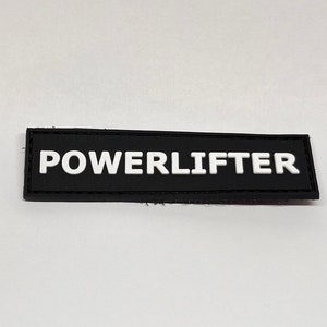 May include: Black rectangular patch with white text that reads "POWERLIFTER".