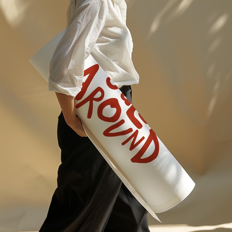 May include: A white yoga mat with the word "AROUND" written in red lettering.