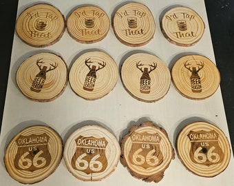 May include: Ten wooden coasters with various designs.  Four coasters feature the text "I'd Tap That" with a beer glass graphic. Four coasters feature a deer head with antlers and the text "Beer Season". Two coasters feature a highway sign with the text "Oklahoma US 66".
