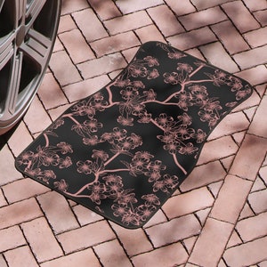 May include: Black car floor mat with a pink floral pattern. The mat is made of a durable material and is designed to protect your car's interior from dirt and spills.