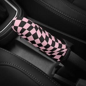 May include: Pink and black checkered car gear shift knob cover.