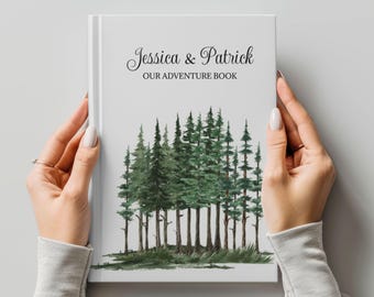 May include: A white book with the text "Jessica & Patrick Our Adventure Book" on the cover. The cover features a watercolor illustration of a forest with green trees.
