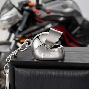 May include: Silver motorcycle helmet keychain with the name "Jason" engraved on the front.