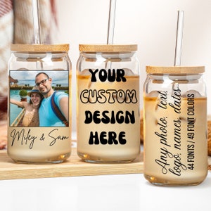 May include: Three glass jars with bamboo lids and straws. The jars are filled with a light brown liquid. The first jar has a photo of a couple in front of a tropical scene. The second jar has the text "YOUR CUSTOM DESIGN HERE" in black. The third jar has the text "Any photo, text, logos, names, dates 44 FONTS/49 FONT COLORS" in black.