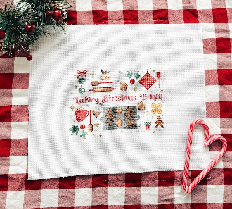 May include: White cross-stitch embroidery on Aida cloth with a red and green Christmas baking theme. The design includes a variety of baking tools, cookies, and the text "Baking Christmas Bright".