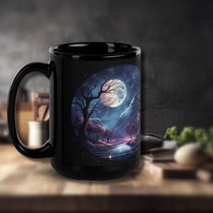 May include: Black ceramic mug with a full-color image of a moonlit forest scene. The scene features a large moon, a lake, trees, and mountains. The mug is 15 ounces.