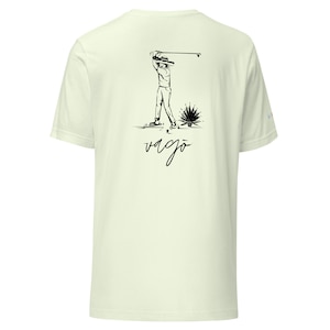 May include: A light green t-shirt with a black illustration of a golfer swinging a club. The text "vago" is printed below the illustration.