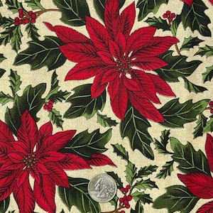 May include: Red poinsettia flowers and green holly leaves on a cream background. The fabric is perfect for holiday crafts and projects.