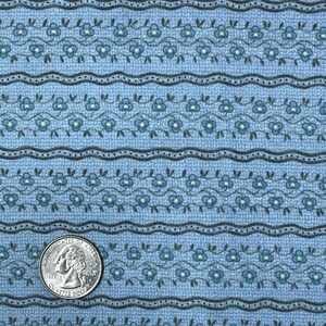 May include: Blue fabric with a repeating pattern of small white flowers and dark gray vines. The fabric has a textured surface and a subtle striped pattern.