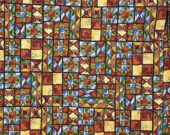 May include: A fabric with a repeating pattern of colorful geometric shapes. The shapes are in shades of red, yellow, blue, and green. The fabric has a textured surface.