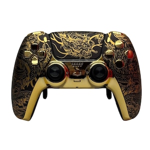 May include: A gold and black PlayStation 5 controller with a dragon design. The controller has a black and gold dragon design on the back and front of the controller.