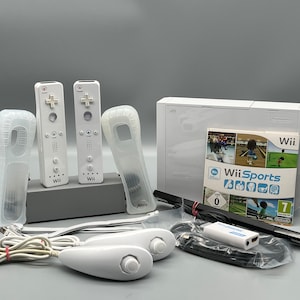 May include: A white Nintendo Wii console with two white Wii remotes, two white Wii motion plus controllers, two white silicone covers for the remotes, a white Wii Sports game disc, a black Wii sensor bar, and a white power adapter.