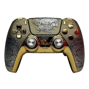 May include: A gold PlayStation 5 DualSense controller with a white dragon design and gold accents. The controller has a textured grip and a black PlayStation logo.