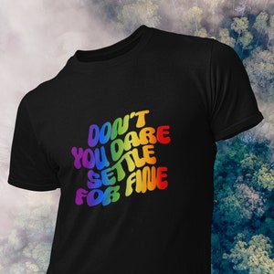 May include: Black t-shirt with a rainbow-colored graphic that says "Don't You Dare Settle For Fine".