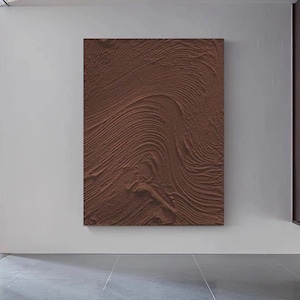 Puede incluir: Una pintura abstracta marr&oacute;n con una superficie texturizada. La pintura tiene un patr&oacute;n de l&iacute;neas y curvas en espiral.