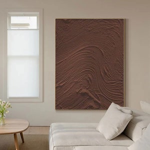 Puede incluir: Impresi&oacute;n de arte abstracto con un patr&oacute;n ondulado marr&oacute;n texturizado. La impresi&oacute;n est&aacute; enmarcada en un marco fino dorado.