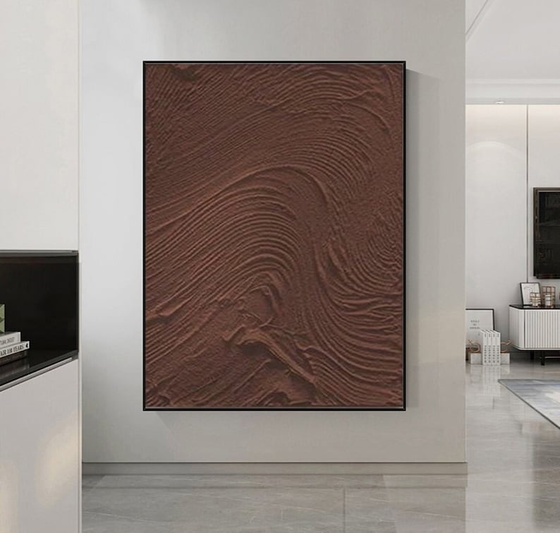 Puede incluir: Impresi&oacute;n de arte abstracto con un fondo texturizado marr&oacute;n. La textura se asemeja a olas o ondulaciones en la arena.