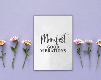 Może przedstawiać: Biała karta z czarnym tekstem, na której widnieje napis "Manifest Good Vibrations" na jasnofioletowym tle z białymi kwiatami.