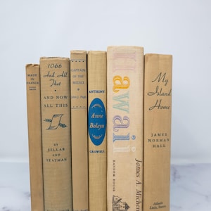 May include: A collection of vintage paperback books with beige covers and colorful titles. The books include "1066 And All That", "Captain of the Medici", "Anthony Anne Boleyn", "Hawaii", and "My Island Home".