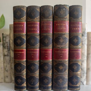 May include: A set of five antique books titled British Poets by Montgomery, volumes I through V. The spines are dark brown and red leather with gold-colored decorative filigree patterns and lettering. The books are arranged vertically in a row.