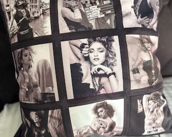 May include: Decorative square pillow featuring a collage of black and white images. The images depict a famous singer in various poses. The pillow has a black border and is likely made of a soft fabric.