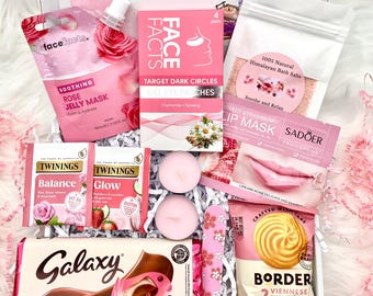 May include: A gift box containing a Face Facts rose jelly mask, gel eye patches, Himalayan bath salts, Sadoer strawberry lip mask, two Twinings tea bags, two pink tea light candles, a floral nail file, and a Galaxy cookie crumble chocolate bar.