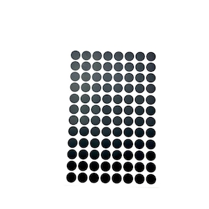 May include: A collection of small, circular stickers arranged in a rectangular grid. The stickers transition in color from light gray at the top to black at the bottom, creating a gradient effect. The background is plain white.