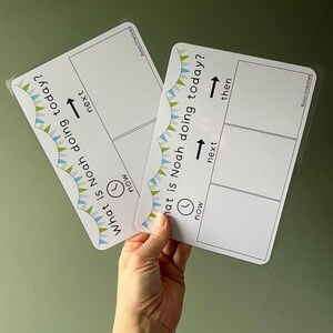 May include: Two white laminated visual schedule boards with rounded corners, featuring a colourful bunting border. The text reads "What is Noah doing today?" with sections labelled "now," "next," and "then" accompanied by clock and arrow icons.