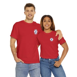 May include: Two people wearing red t-shirts with a small blue, white, and red logo on the left chest. The logo features a diamond shape with a lightning bolt inside.