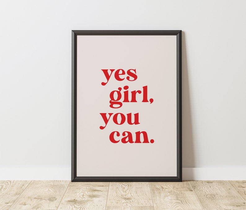 May include: A framed print with the text "yes girl, you can." in red letters on a white background.