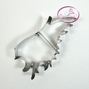 May include: A silver metal cookie cutter shaped like a moose head with a detailed antler design.