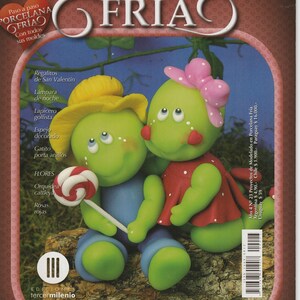 May include: A magazine cover featuring a green and yellow clay figurine of a couple. The magazine is titled "Proyectos de modelado en Porcelana Fría" and has a subtitle "Paso a paso Porcelana Fría Con todos sus moldes".