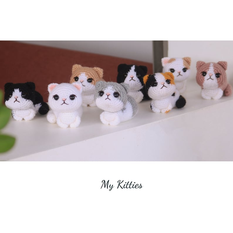 May include: A collection of handmade crochet cat figurines in various colors, including white, black, gray, and brown. Each cat has detailed features and is posed in a sitting or lying down position. The text "My Kitties" is at the bottom.