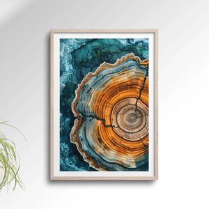 May include: Abstract art print featuring a close-up of a tree's rings in shades of blue, green, orange, and brown. The rings are arranged in a circular pattern, with a crack running through the centre.