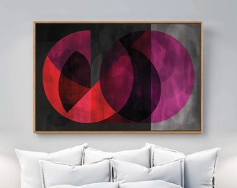 Può includere: Stampa d'arte geometrica astratta con cerchi sovrapposti in tonalità di rosa, rosso e nero su sfondo grigio. La stampa è incorniciata in una cornice in legno chiaro.