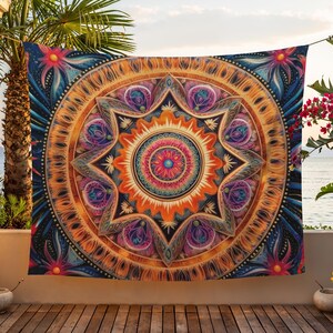 May include: A vibrant tapestry with a detailed mandala design. The artwork features a central starburst pattern in orange, pink, and blue, surrounded by intricate floral and geometric elements. The tapestry is displayed outdoors, adding a touch of bohemian flair.