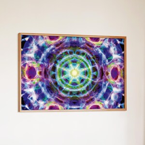 May include: A rectangular wall art print in a light wood frame featuring a vibrant, symmetrical mandala-like pattern. The design displays swirling clouds of blue, purple, green, and yellow hues radiating from a bright, central white light point.