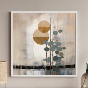 May include: Abstract painting with a white background, featuring two overlapping gold circles and a stylized green plant with leaves. The painting is framed in a white frame.