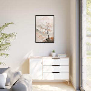 May include: A framed watercolour painting of a misty mountain landscape with a single tree in the foreground. The painting is in shades of grey, brown, and pink.