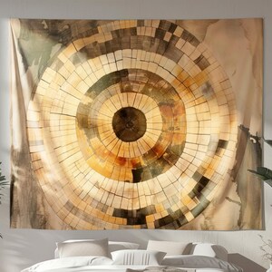 May include: A large tapestry with a circular design resembling a cross-section of a tree trunk. The artwork features concentric rings in shades of brown, beige, and gold, creating a warm and natural aesthetic. The tapestry is hung above a bed.
