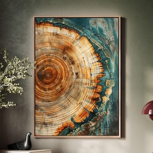 May include: A framed abstract art print featuring a close-up of a tree trunk's rings. The rings are a mix of brown, orange, and yellow, with a blue and green background.