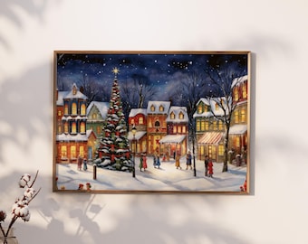 Puede incluir: Una impresión enmarcada de una escena de pueblo invernal. La obra representa edificios cubiertos de nieve con ventanas iluminadas, un árbol de Navidad decorado y figuras caminando por la calle nevada bajo un cielo estrellado.