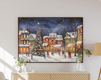 Puede incluir: Pintura enmarcada de una escena invernal nevada con un árbol de Navidad en una plaza del pueblo. Edificios con ventanas iluminadas bordean la calle, y figuras pasean por el camino nevado bajo un cielo estrellado. La obra está enmarcada en un marco negro.