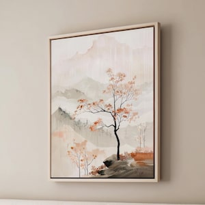 May include: A framed painting depicting a misty mountain landscape with a solitary tree in the foreground. The tree has delicate branches and leaves in shades of brown and orange. The background is a soft blend of pale pink, grey, and white.