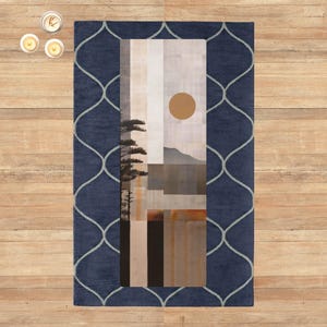 May include: A rectangular rug with a navy blue border featuring a light gray, geometric pattern. The center of the rug displays an abstract landscape painting with a sun, mountains, and trees. The rug is placed on a wooden floor.