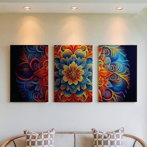 May include: Three canvas art pieces with vibrant floral designs. The artwork features a central piece with a large, detailed flower in shades of blue, orange, and yellow, flanked by two complementary panels with swirling patterns.
